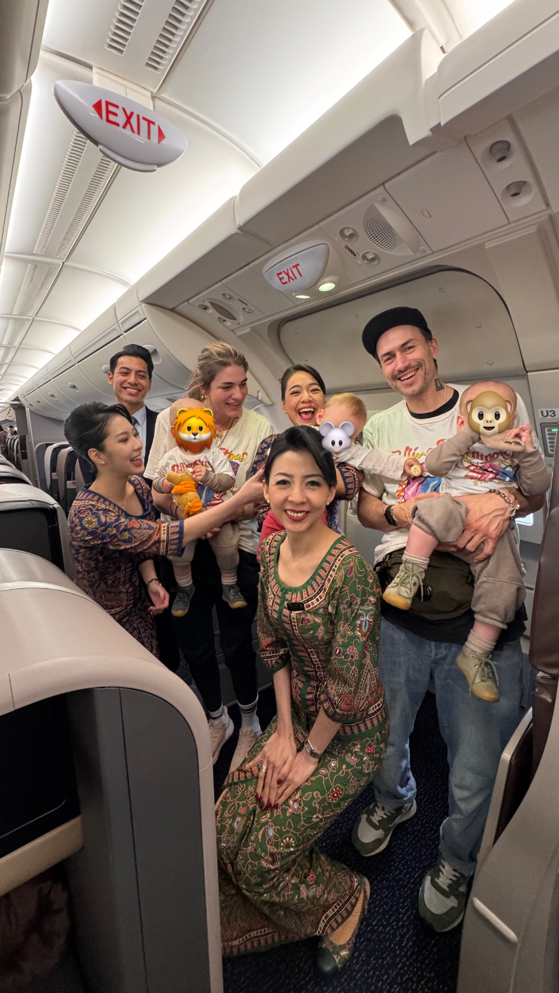 Papa mit schlafendem Baby im Business-Class-Flatbed